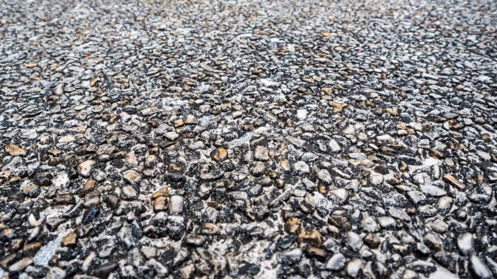 Close-up of dark exposed quartz aggregate flooring texture